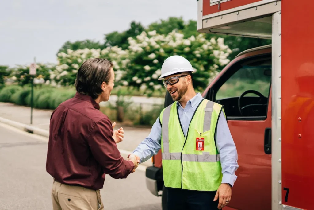 Rainbow Restoration technician shaking hands with a client on-site