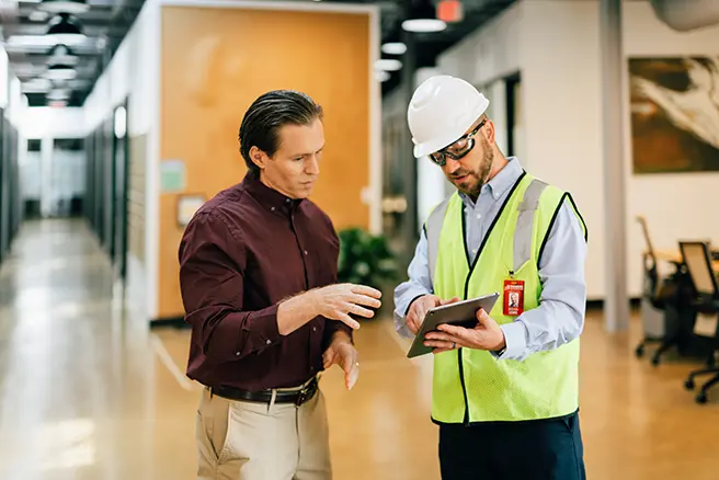 Technician reviewing restoration details with a contractor