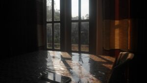 Sunlight on standing water inside a home — water damage in a Florida interior